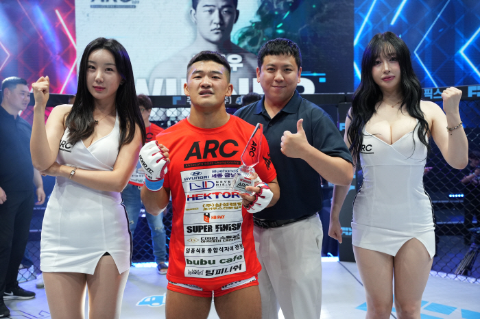 Fighter100 CEO Oh In-taek presents the trophy to Kim Hyun-woo, who won 