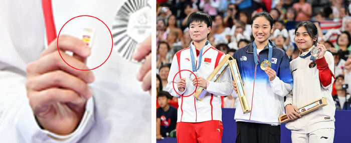 Badminton silver medal in the hands of a player 'Spanish team badges' and the reason 'Impression'