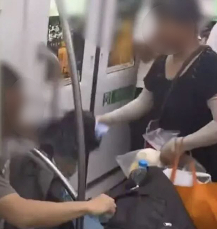 'Why don't you give up your seat on the subway?'Wielding an umbrella for an elderly woman