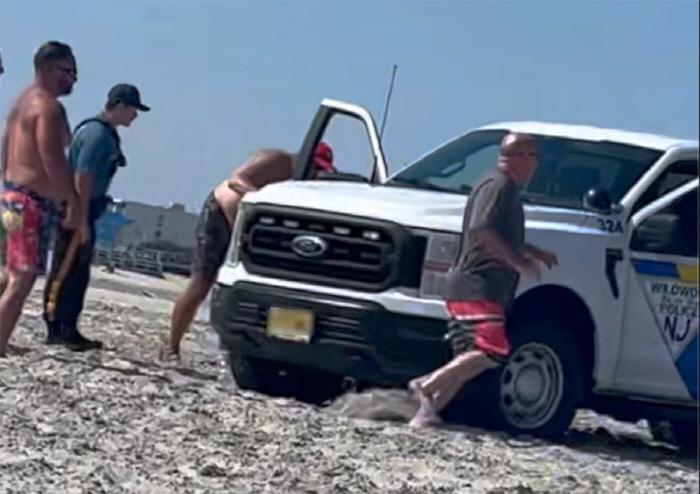 Woman sunbathing on beach seriously hit by police car