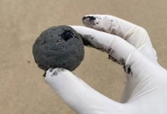 What is the black object the size of a golf ball found on the beach?