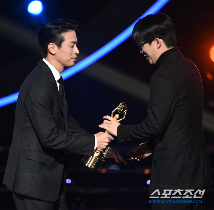  Director Cho Hyun-chul receives the rookie director's trophy from Park Jung-min