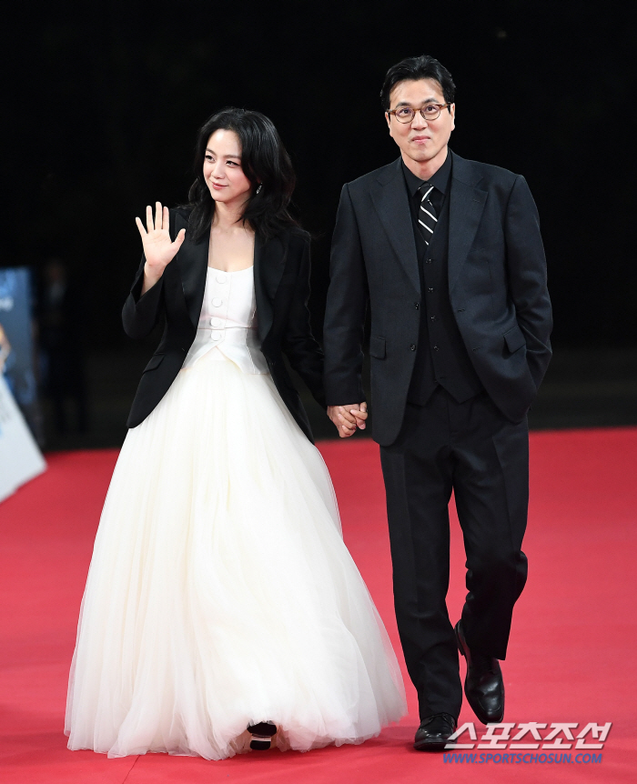  Director Tang Wei and Director Kim Taeyong, holding hands in a kind way